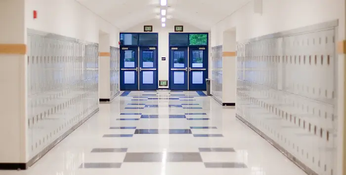 Schools Hallway of a school with lockers and doors on the sides